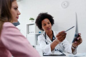 Doctor talking with patient at desk