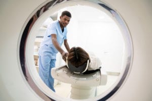 radiologist getting ready a patient for a CT scan