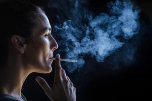 Profile view of beautiful woman smoking