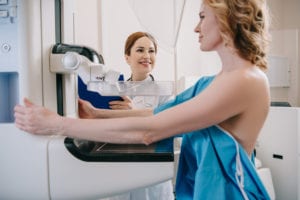 A Doctor doing mammography of a patient