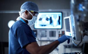 Doctor analysing patient report on screen