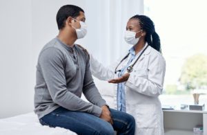 Female doctor talking to a male patient