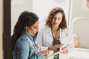 A female doctor discusses a young patient's diagnosis