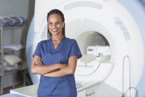 Technician standing in front of MRI scanner