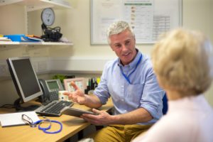 Primary care doctor giving consultancy to a elder woman