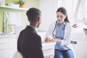 Primary Care doctor is writing a prescription in her office