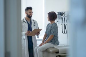 Senior Talking with the Primary Care Doctor About a Flu Shot