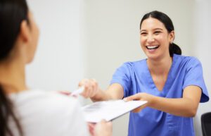 Shot of a patient and assistant interacting in a primary care office