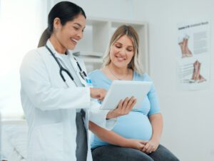 women's physician during a consultation with a pregnant patient in a clinic