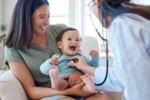 primary care doctor examining baby child