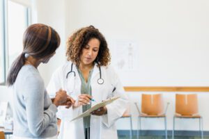 Attentive female patient discusses test results with doctor