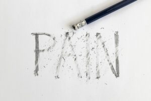 Pain written on white paper with a pencil, erased with an eraser